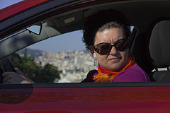 Lady driving a red car