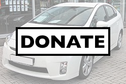 White car with sign "Donate"