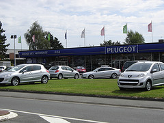 Car dealer's yard with silver cars